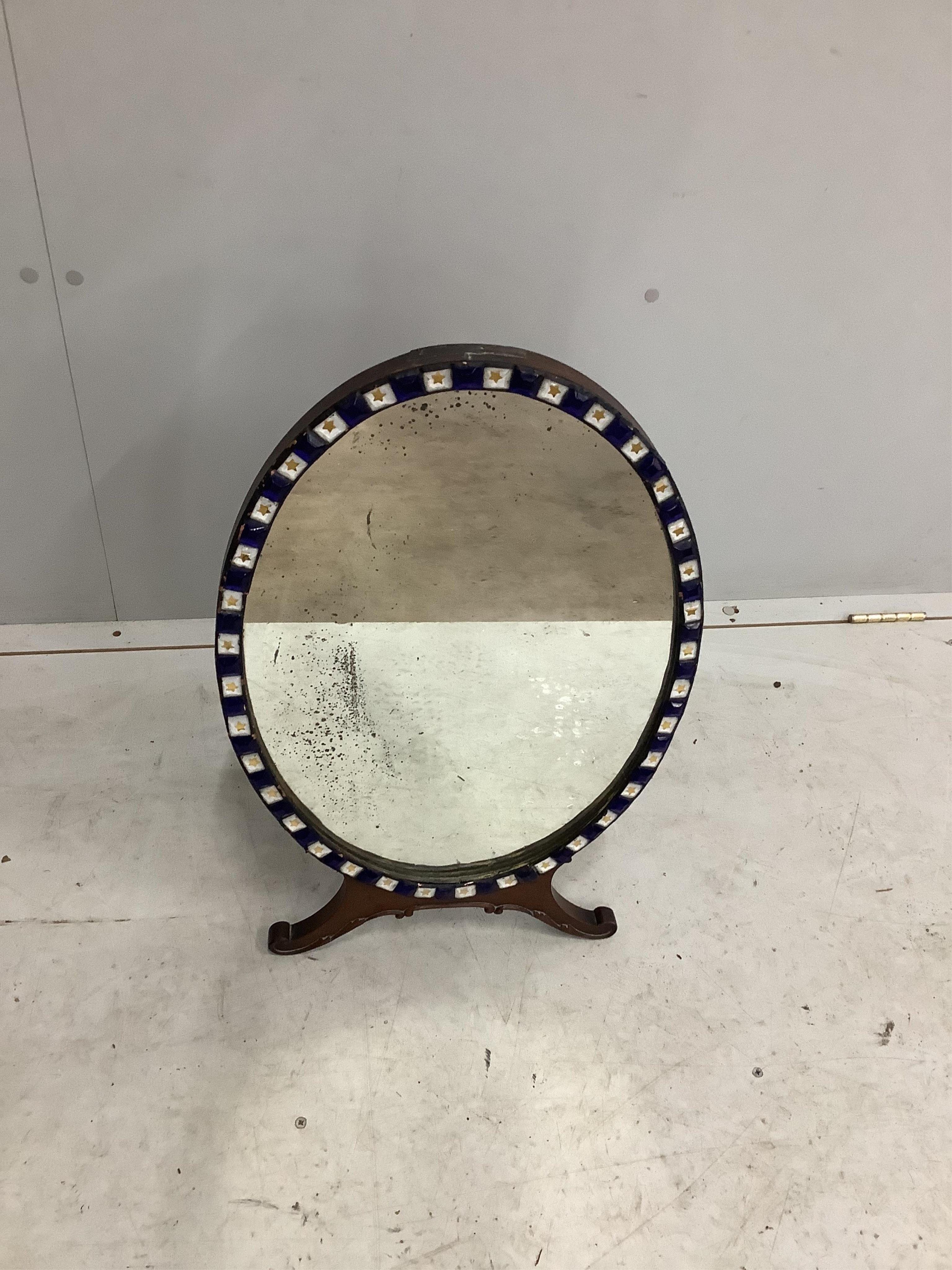 An early 20th century Irish glass bead applied mahogany toilet mirror, modelled in the 18th century manner and with label for M Butler of Dublin, width 40cm, height 62cm. Condition - fair